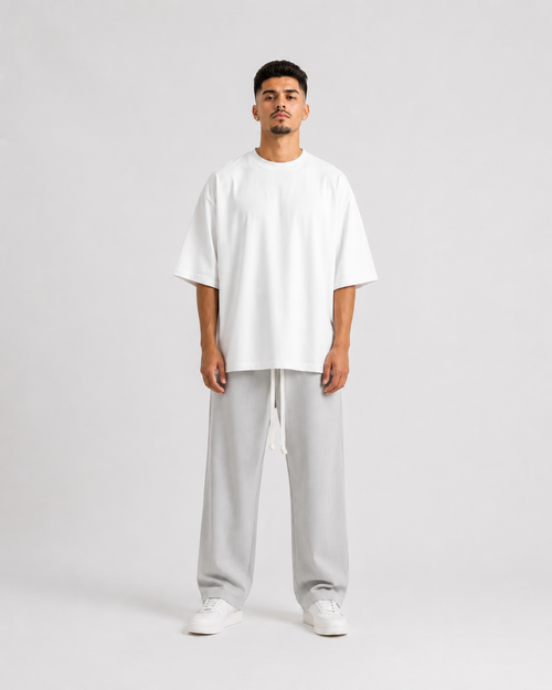 Grey wide leg men’s pants with long white drawstrings, oversized relaxed fit, luxury streetwear design shown on male and female models