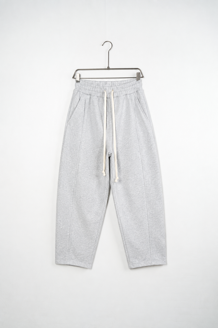 Pantaloni Baggy Felpați Bărbați Gri Melanj, vedere frontală pe umeraș, fundal deschis
