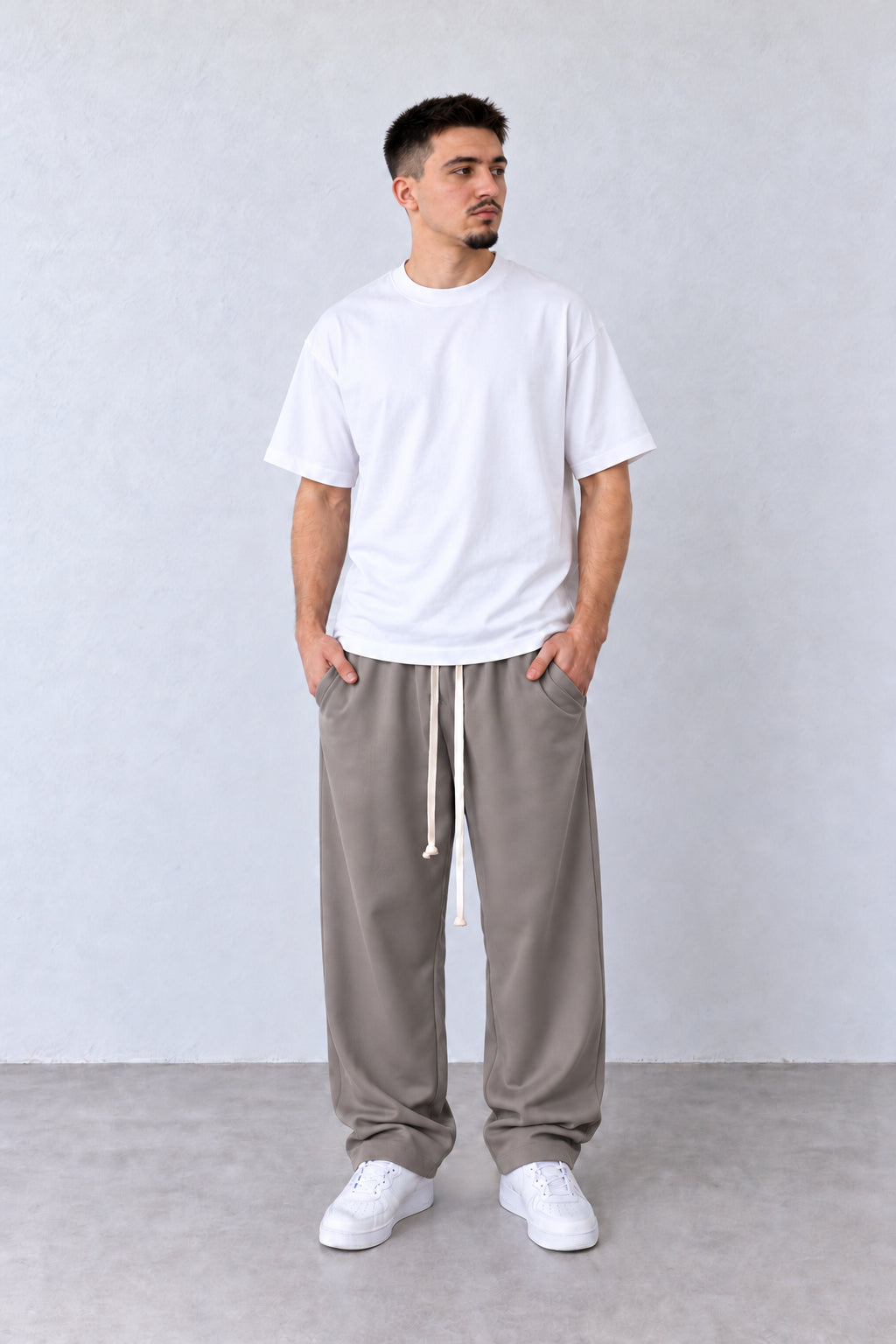 Pantaloni Bărbați Grej Largi cu Șnur Lung, vedere integrală pe model cu capul ușor întors sau înclinat.