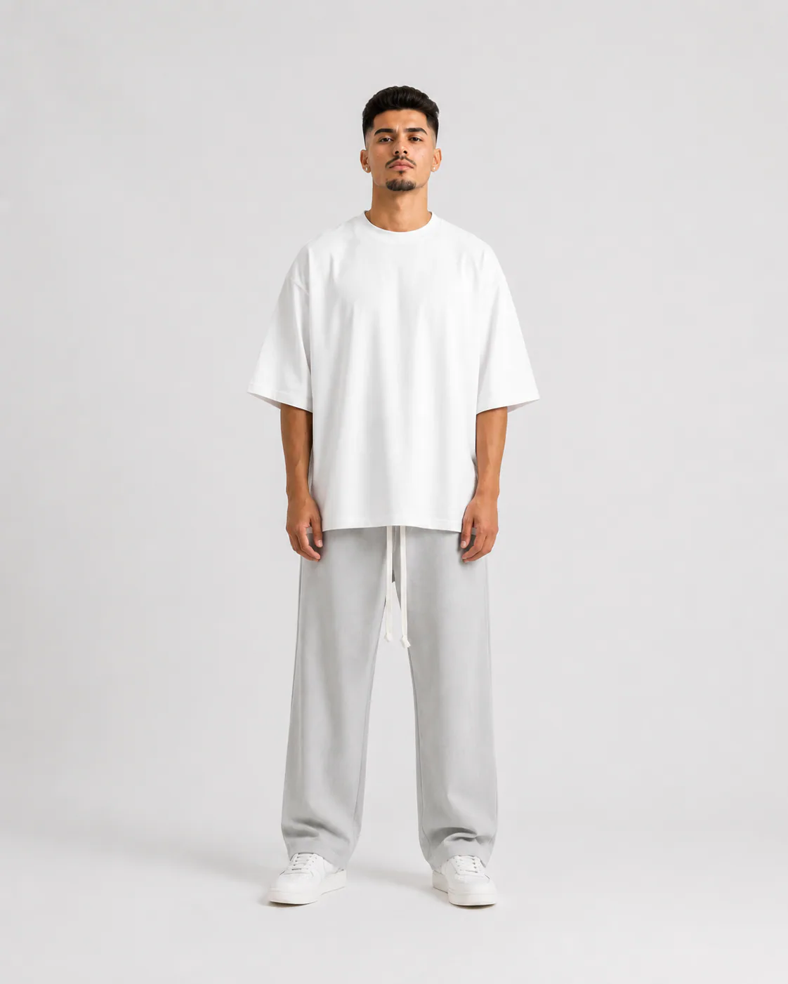 Grey wide leg men’s pants with long white drawstrings, oversized relaxed fit, luxury streetwear design shown on male and fema
