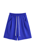 Pantaloni albastru regal oversized cu șnur lung în talie, având o cusătură decorativă frontală pe centrul piciorului, confecționați dintr-un amestec de bumbac și poliester.